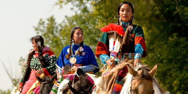 native women riding horses at Crow Fair, Crow Agency