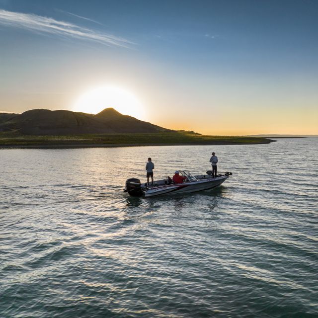 Boat on Fort Peck Reservoir with sun setting